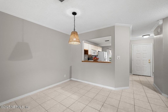 unfurnished room featuring light tile patterned floors, baseboards, ornamental molding, and a textured ceiling