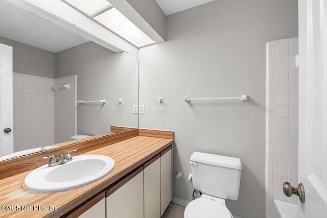 full bathroom with a skylight, vanity, toilet, and bathing tub / shower combination