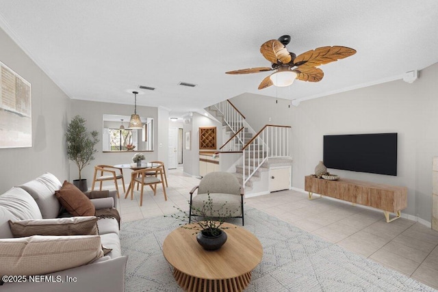 7701 Baymeadows Cir W Unit 1154, Jacksonville, FL 32256 - tiled living room with stairs, ornamental molding, visible vents, and baseboards