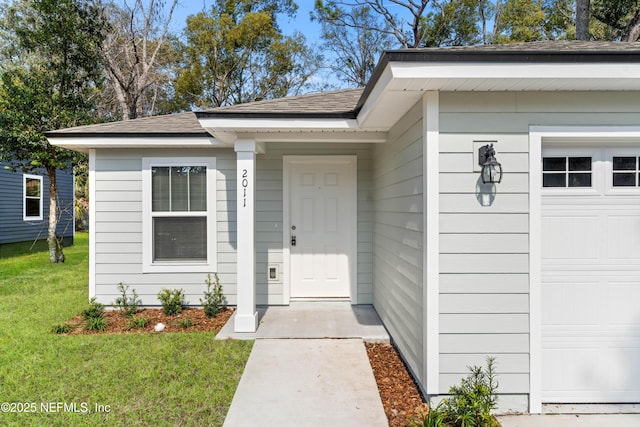 doorway to property with a lawn