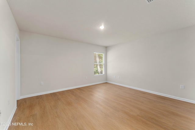 empty room with light hardwood / wood-style flooring