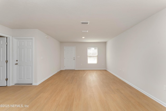 unfurnished room with light hardwood / wood-style flooring