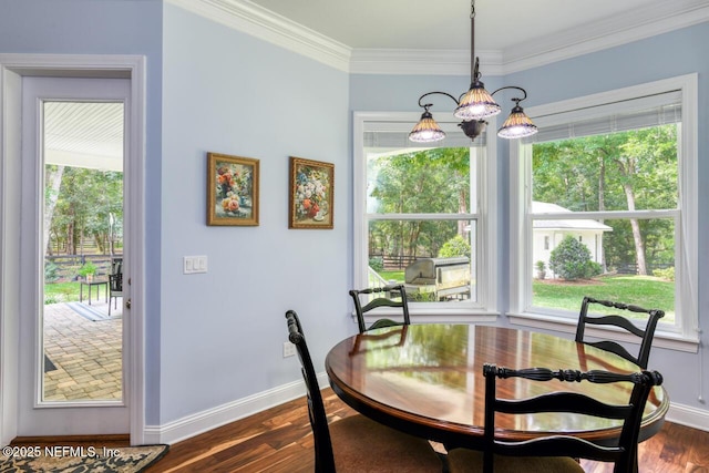 dining area featuring dark hardwood / wood-style flooring and crown molding