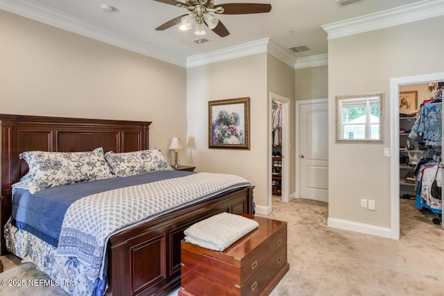 bedroom featuring light colored carpet, ornamental molding, a spacious closet, and a closet