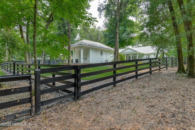 view of gate featuring an outbuilding