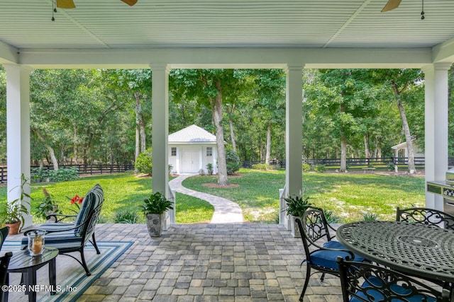 view of patio featuring an outdoor structure and ceiling fan