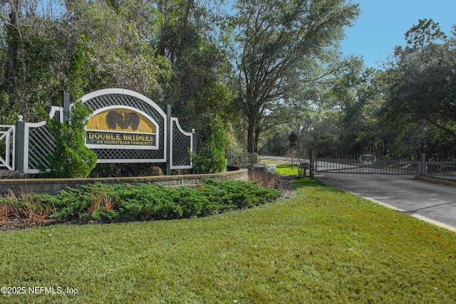 community sign featuring a lawn