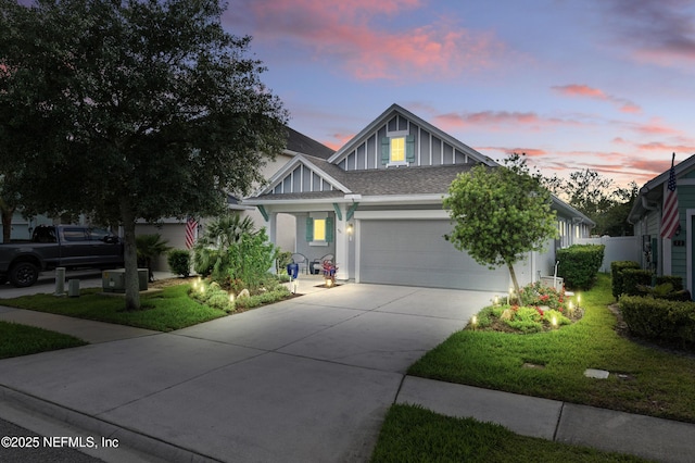 63 Park Lake Dr, Ponte Vedra, FL 32081 - view of front facade featuring an attached garage, concrete driveway, roof with shingles, and a yard