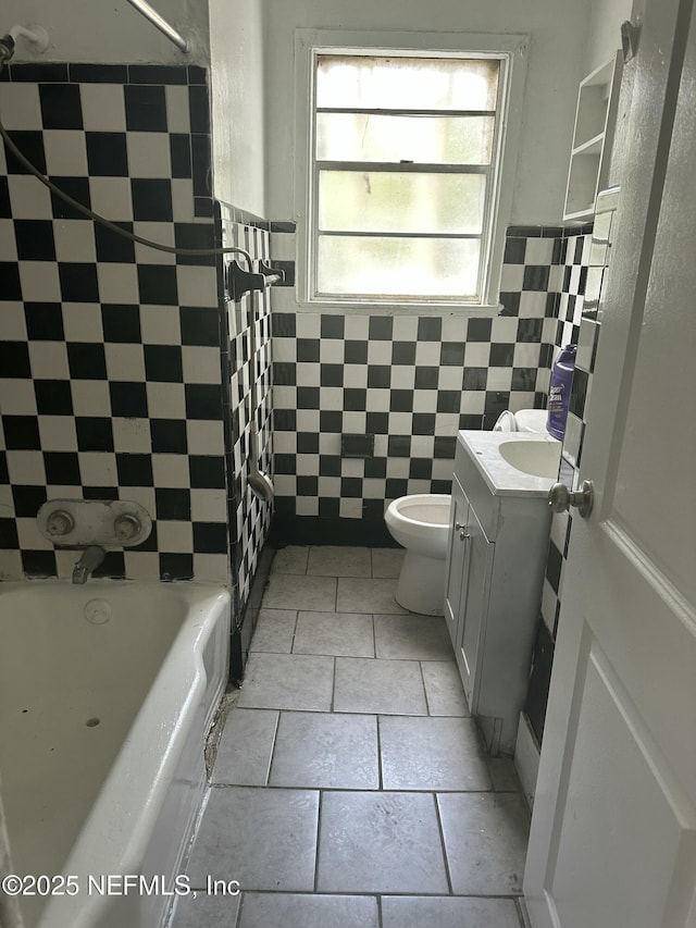bathroom with vanity, tile patterned flooring,  shower combination, toilet, and tile walls