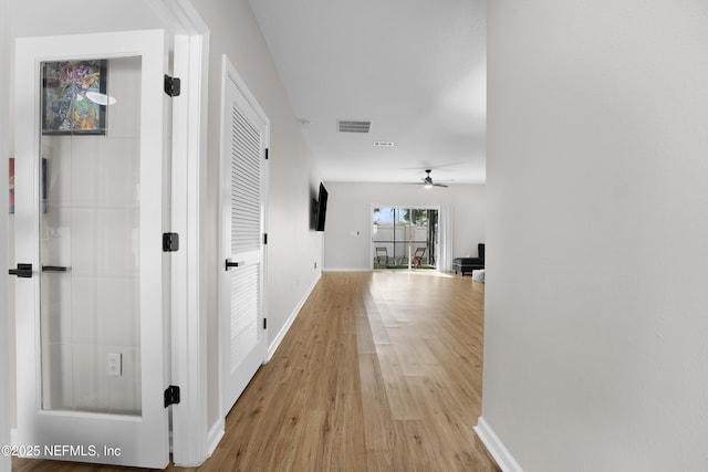 corridor with light wood-type flooring