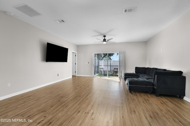 living room featuring ceiling fan and light hardwood / wood-style floors