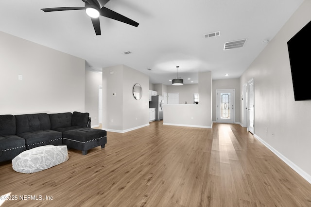 living room featuring ceiling fan and light wood-type flooring