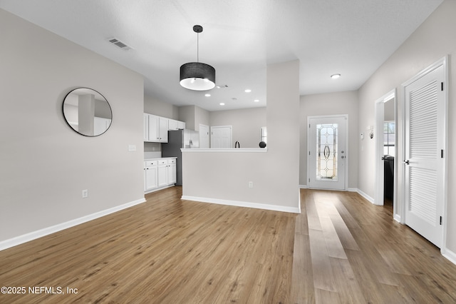 unfurnished living room with light hardwood / wood-style flooring