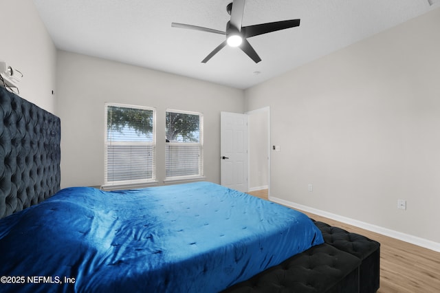 bedroom with wood-type flooring and ceiling fan