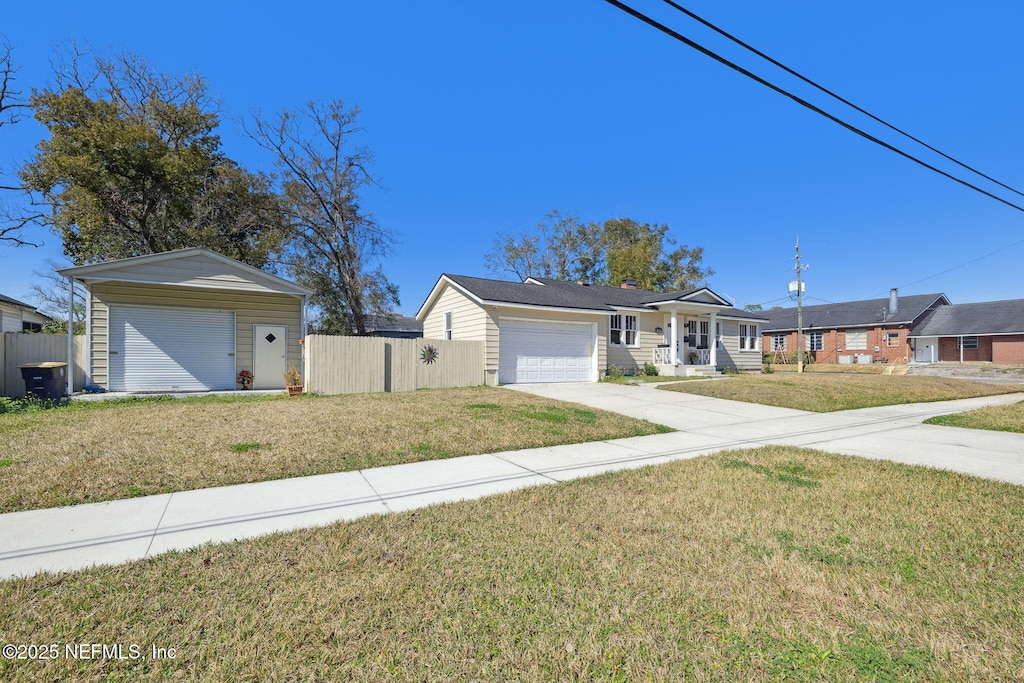 2136 Bayview Rd, Jacksonville, FL 32210 - ranch-style house with driveway, a front yard, fence, and a residential view