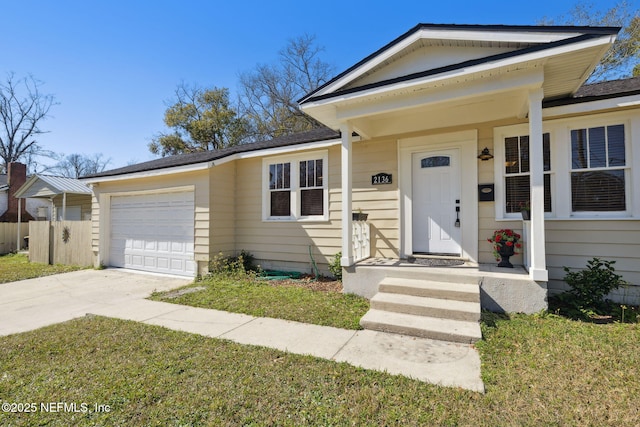 view of front of house with a garage and a front lawn