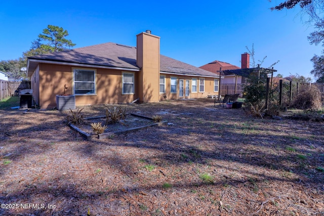 back of property with a pergola and central AC