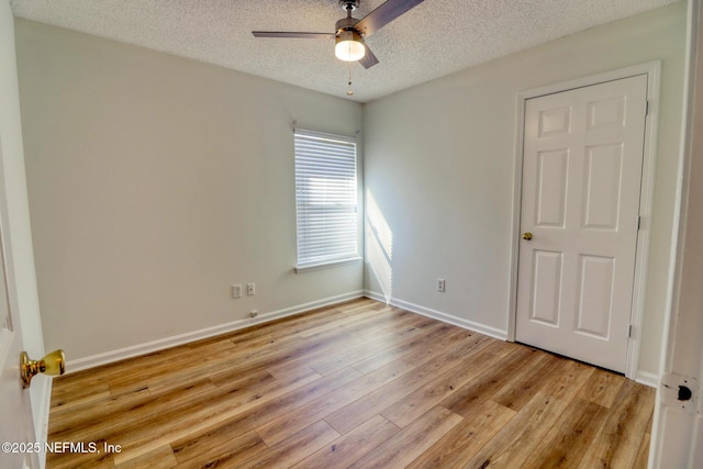 spare room featuring ceiling fan, a textured ceiling, and light hardwood / wood-style floors