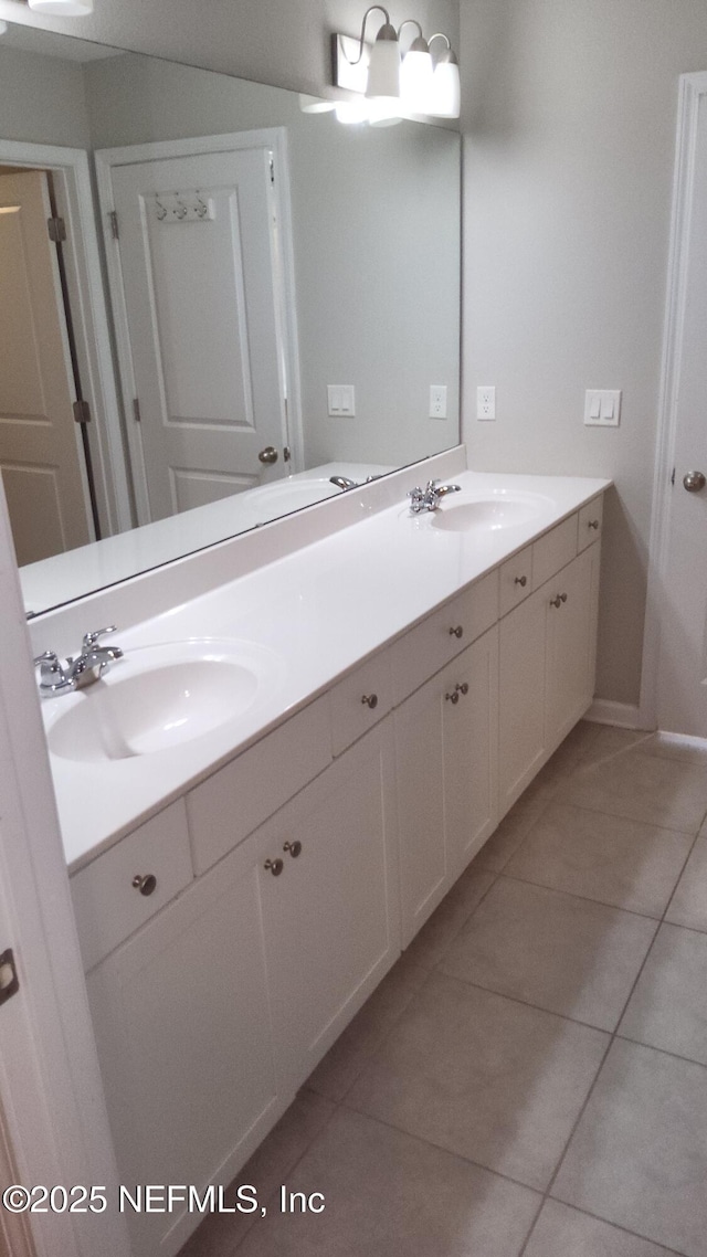 bathroom featuring tile patterned flooring and vanity