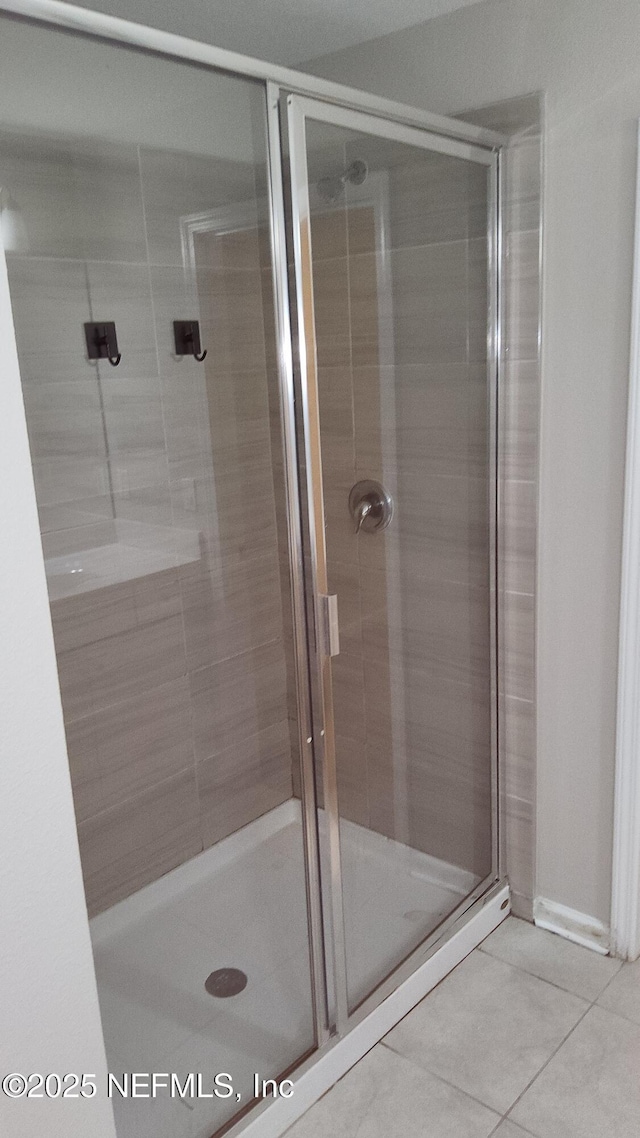 bathroom with tile patterned floors and walk in shower