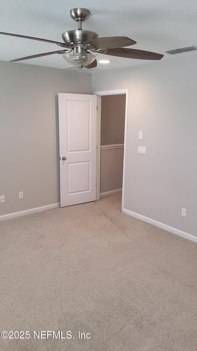 carpeted empty room with ceiling fan