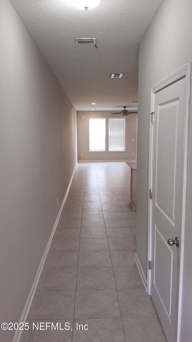 hallway featuring light tile patterned floors