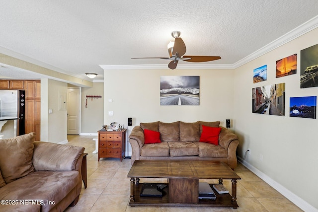 tiled living room with ceiling fan, ornamental molding, and a textured ceiling