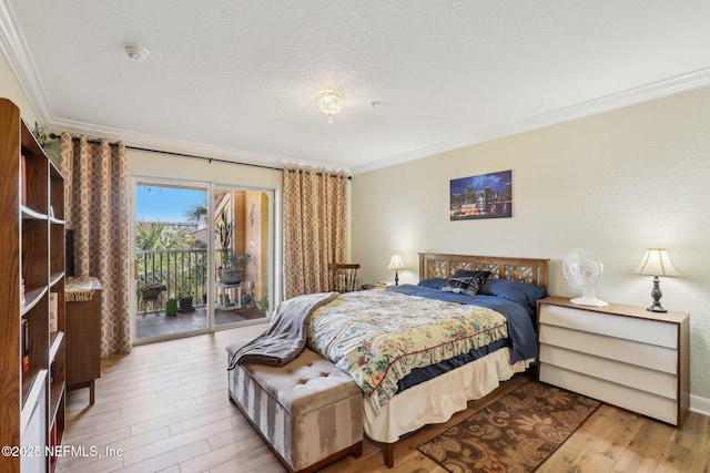 bedroom with a textured ceiling, ornamental molding, wood finished floors, and access to exterior