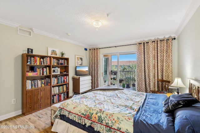 bedroom featuring crown molding, light wood finished floors, visible vents, a textured ceiling, and access to outside