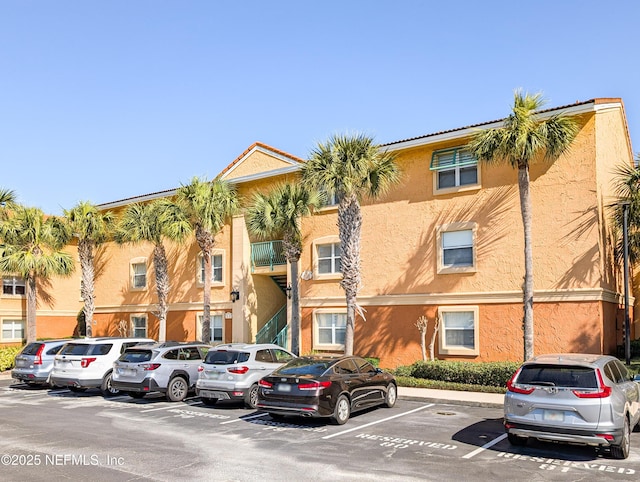 view of property featuring uncovered parking