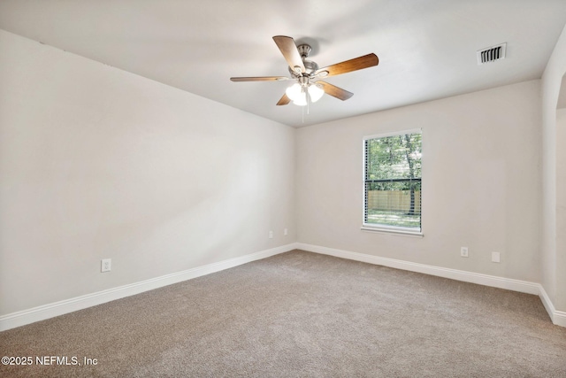 carpeted spare room featuring ceiling fan