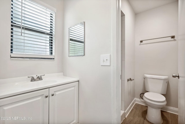 bathroom featuring hardwood / wood-style flooring, vanity, and toilet