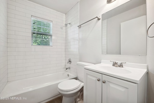 full bathroom with tiled shower / bath, vanity, and toilet