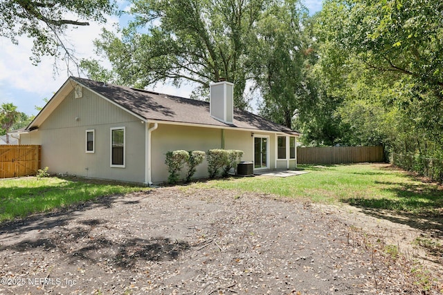 back of property featuring a lawn, central AC unit, and a patio area