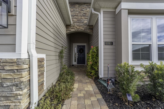 property entrance with stone siding