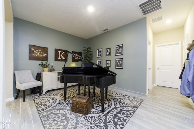 living area with visible vents and baseboards