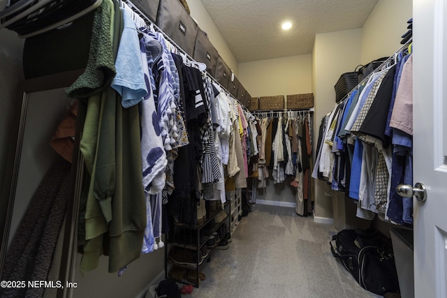 walk in closet with light colored carpet