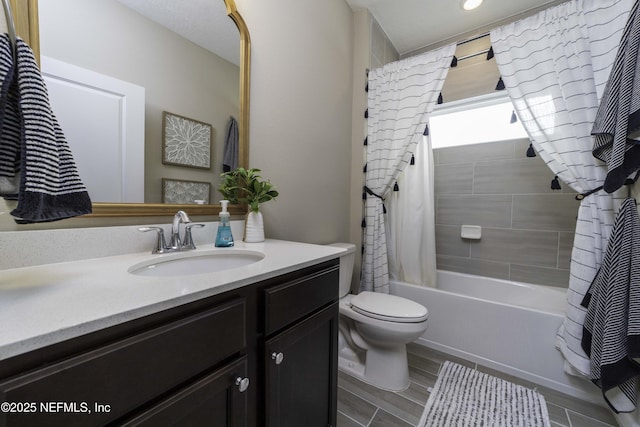 full bath with toilet, shower / bath combination with curtain, and vanity