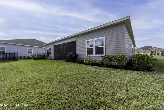 rear view of property featuring a lawn