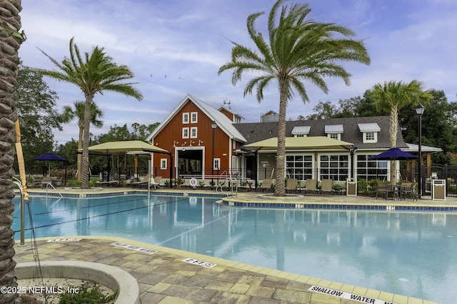 community pool featuring a patio area and fence