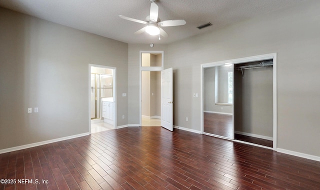 unfurnished bedroom featuring hardwood / wood-style floors, a closet, a textured ceiling, and ceiling fan