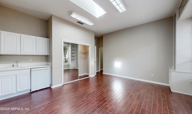 kitchen featuring white cabinetry, dishwasher, sink, and dark hardwood / wood-style flooring