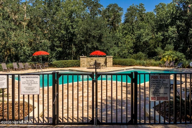 view of swimming pool with a patio area