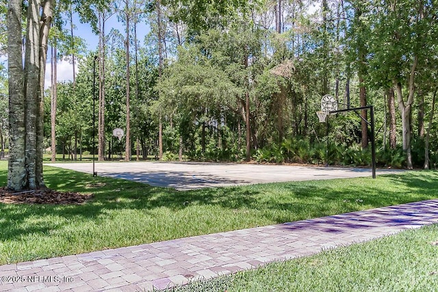 view of basketball court featuring a lawn