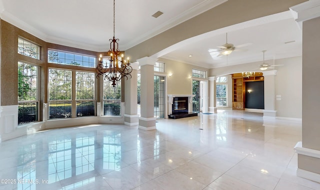 unfurnished living room with crown molding, ceiling fan, and ornate columns