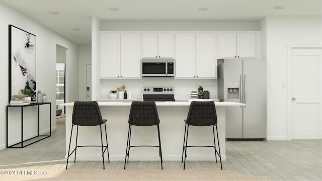 kitchen with white cabinetry, appliances with stainless steel finishes, light hardwood / wood-style floors, and a kitchen island