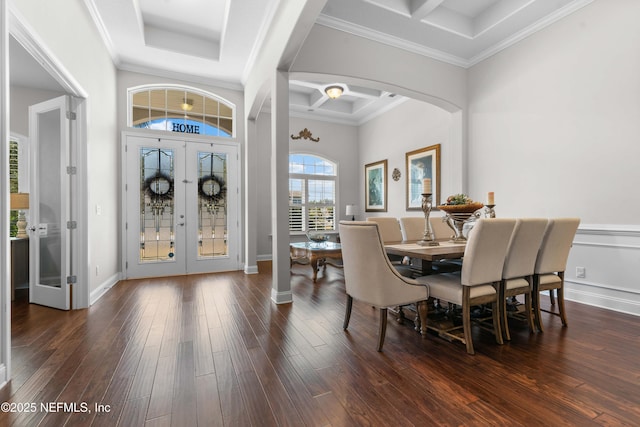 dining space with french doors, dark wood-type flooring, coffered ceiling, crown molding, and beam ceiling