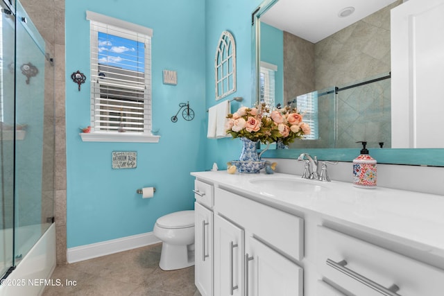 full bathroom featuring enclosed tub / shower combo, vanity, toilet, and tile patterned flooring