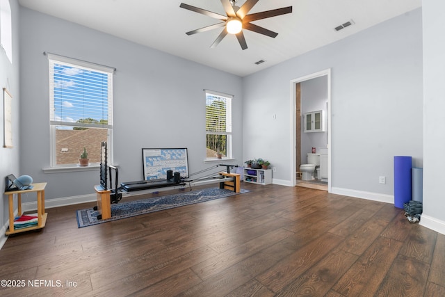 workout room featuring dark wood-type flooring and ceiling fan