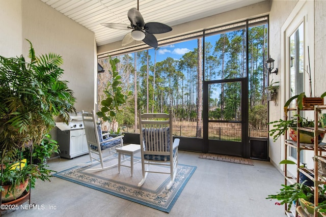 sunroom / solarium with ceiling fan and a healthy amount of sunlight